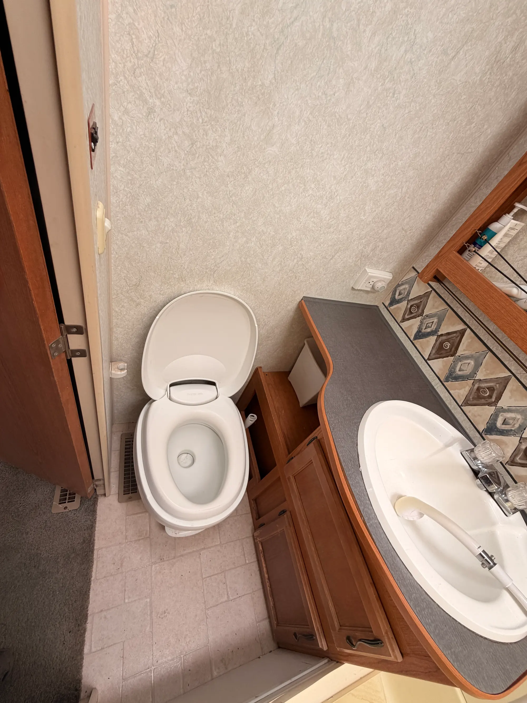 Bathroom with a flush toilet, vanity sink and mirrored medicine cabinet